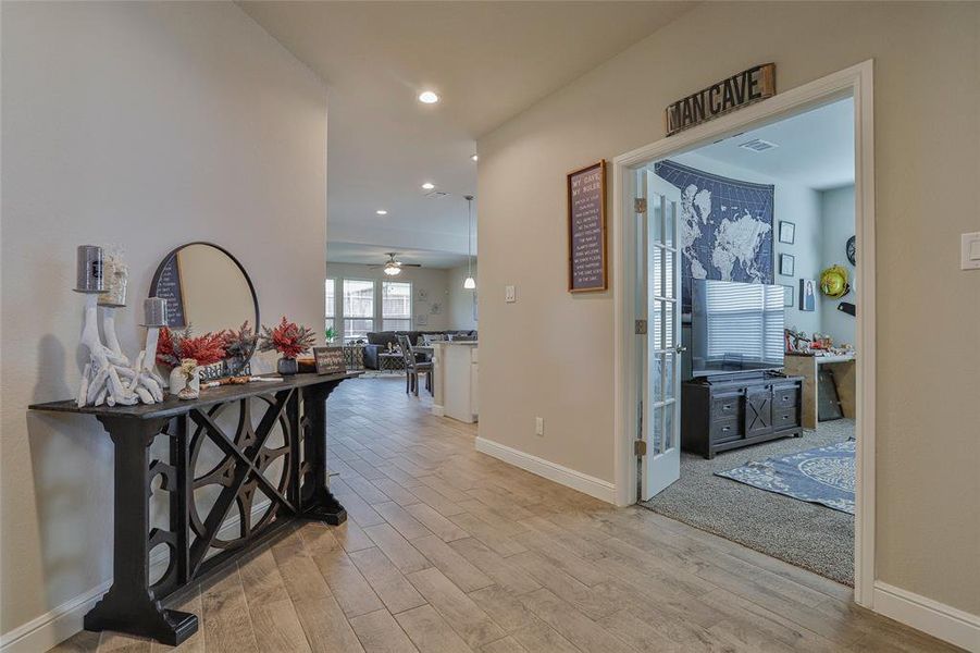 Hallway featuring light wood-style floors and recessed lighting Hallway featuring light wood-style floors and recessed lighting