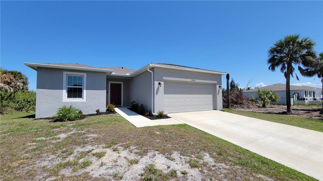 Front exterior of a new home in Harbour Heights, Punta Gorda, FL, highlighting curb appeal (Image 22).