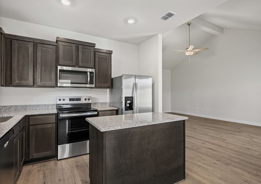 The kitchen has beautiful wood cabinetry.