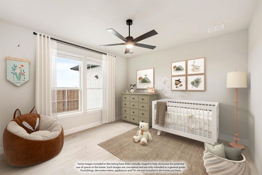 Nursery with white crib, green dresser, ceiling fan, and light wood floors