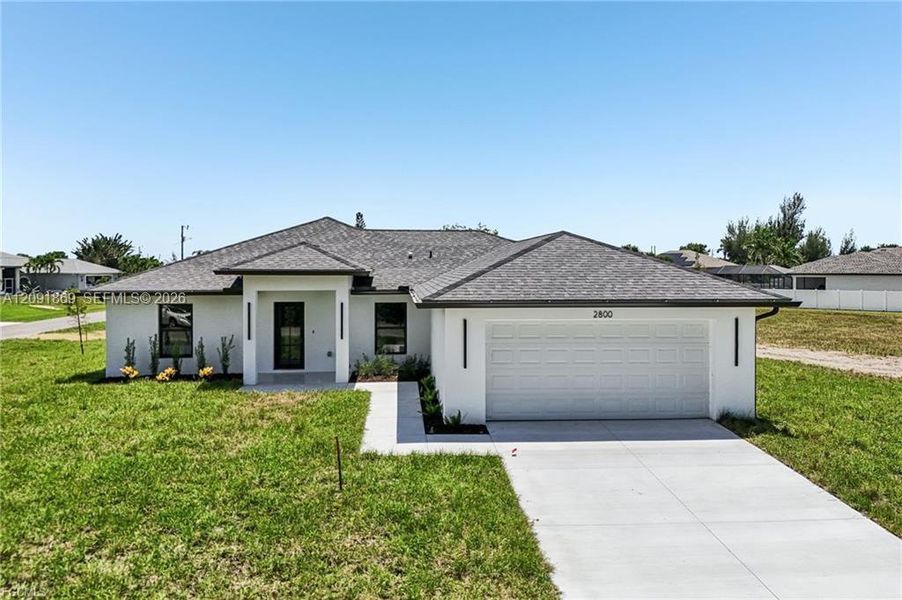Front exterior of a new home in , Cape Coral, FL, highlighting curb appeal (Image 2). Front exterior of a new home in , Cape Coral, FL, highlighting curb appeal (Image 2).