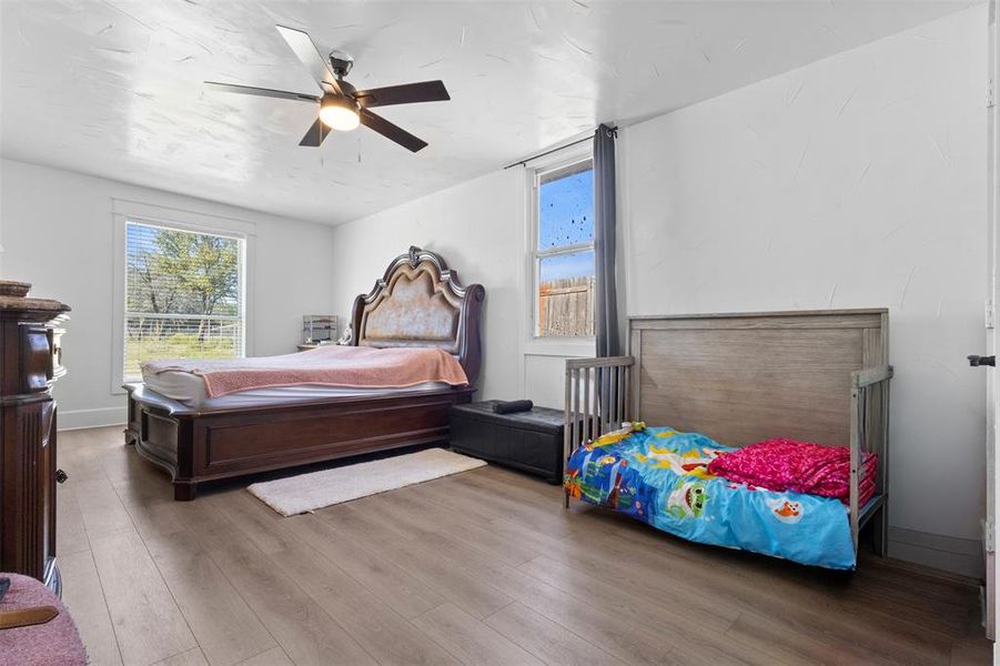 Bedroom with wood finished floors and a ceiling fan Bedroom with wood finished floors and a ceiling fan