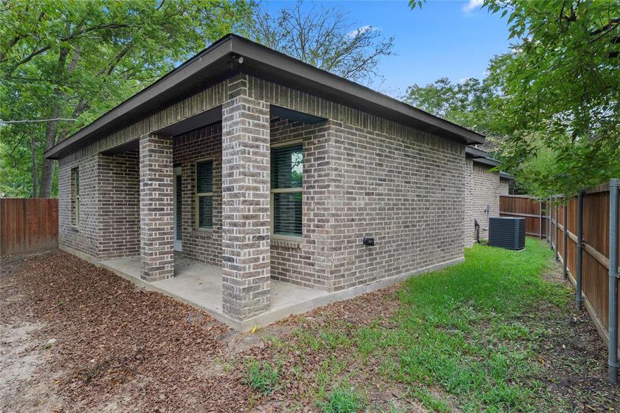 View of home's exterior featuring a fenced backyard and brick siding View of home's exterior featuring a fenced backyard and brick siding