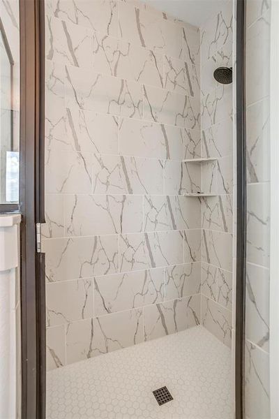 Bathroom featuring a tile shower