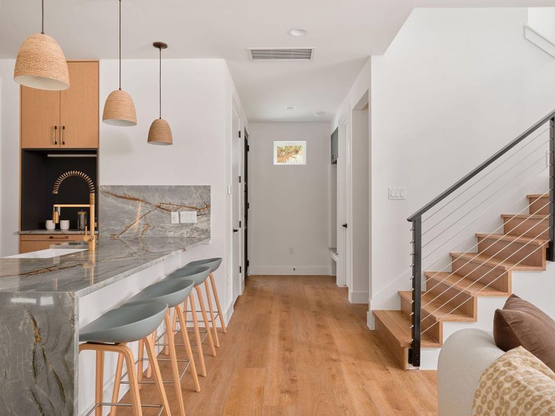 Foyer entrance featuring light wood finished floors, stairs, and recessed lighting Foyer entrance featuring light wood finished floors, stairs, and recessed lighting