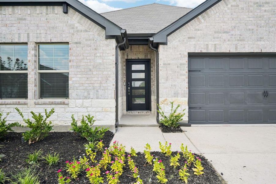 Front exterior of a new home in Lakehaven - Signature Series, Farmersville, TX, highlighting curb appeal (Image 22). Front exterior of a new home in Lakehaven - Signature Series, Farmersville, TX, highlighting curb appeal (Image 22).