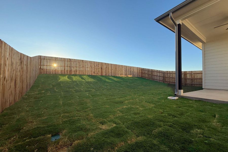 Fenced backyard featuring a patio
