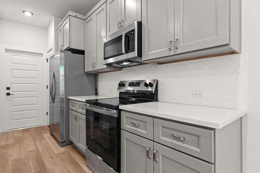 Prepare culinary creations in this well-appointed kitchen featuring sleek appliances and abundant cabinetry. Prepare culinary creations in this well-appointed kitchen featuring sleek appliances and abundant cabinetry.