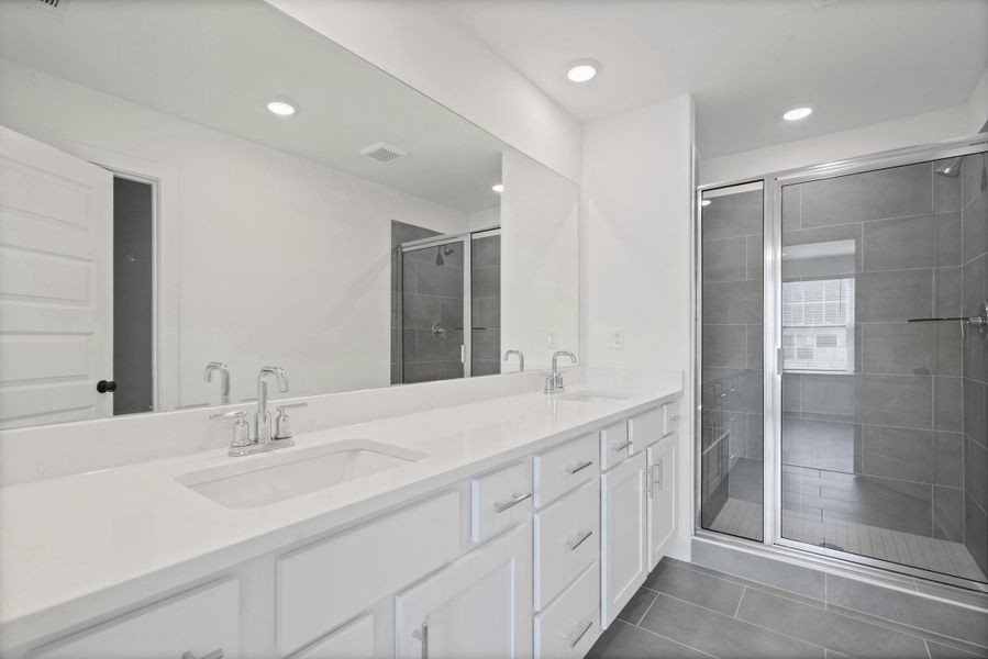 Dual vanity with integrated sinks, white cabinetry, and a full-width mirror