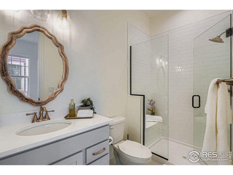 Main Level Bedroom ensuite bath with frameless shower door. Main Level Bedroom ensuite bath with frameless shower door.