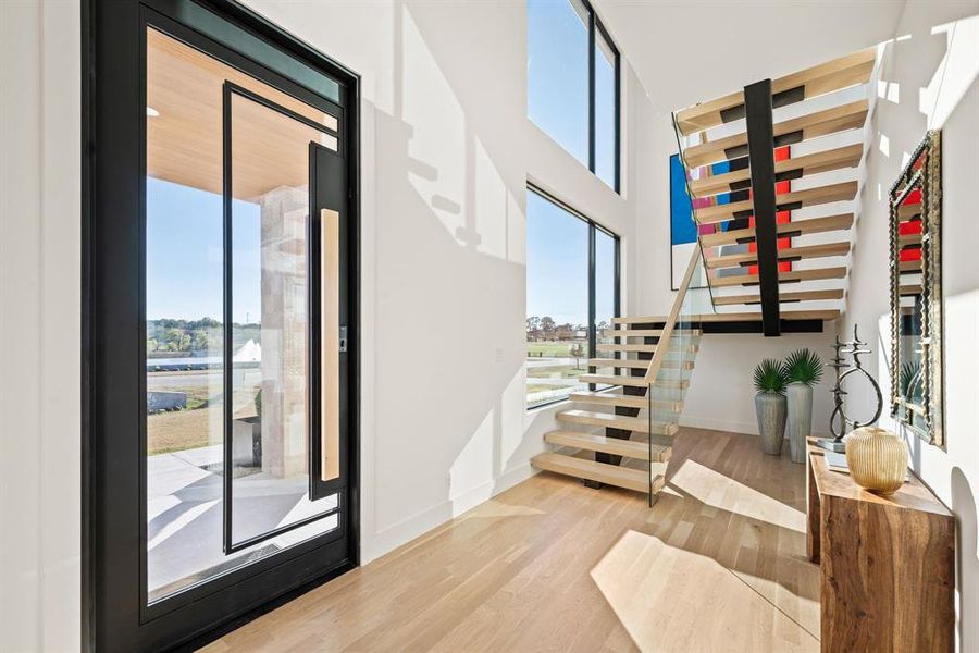 Light-filled entry with floating staircase and contemporary design. Light-filled entry with floating staircase and contemporary design.