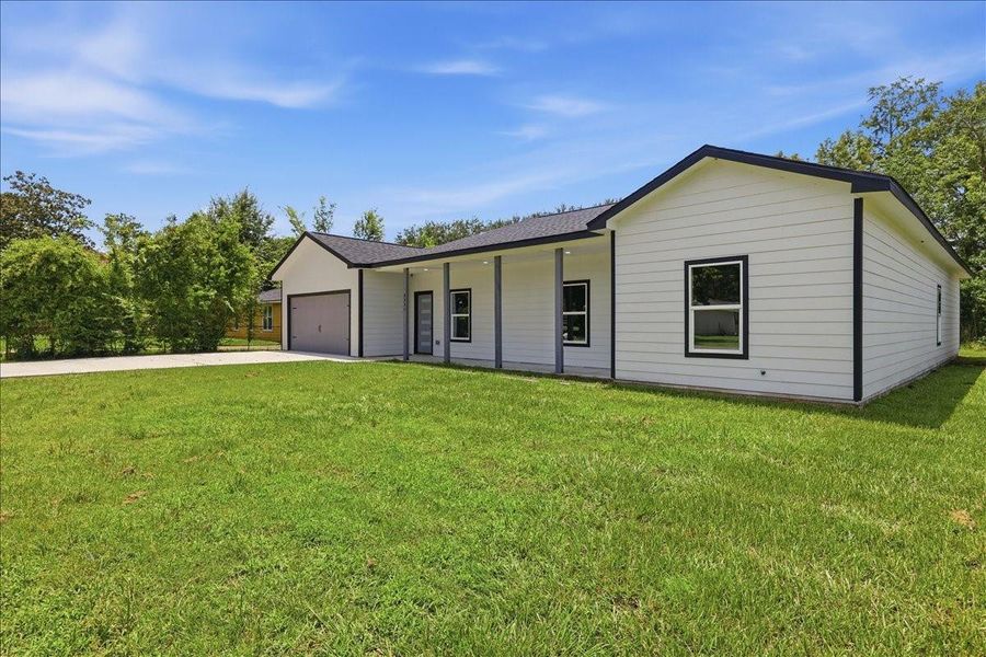 Modern one-story design showcasing clean architectural lines and an expansive front yard. Modern one-story design showcasing clean architectural lines and an expansive front yard.