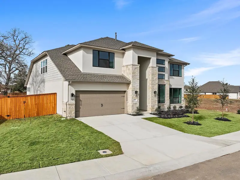 Front exterior of a new home in Parmer Ranch, Georgetown, TX, highlighting curb appeal (Image 23).