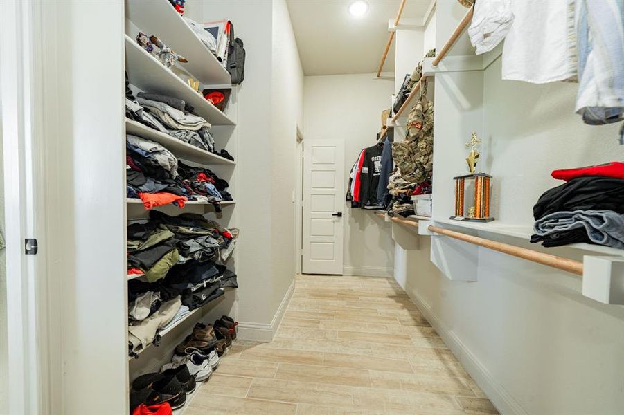 Spacious closet featuring wood tiled floors Spacious closet featuring wood tiled floors