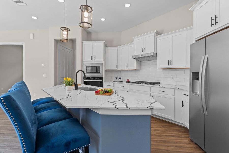 The Portico kitchen combines style and function with sleek finishes, ample counter space, and an open layout that keeps you connected while you cook.