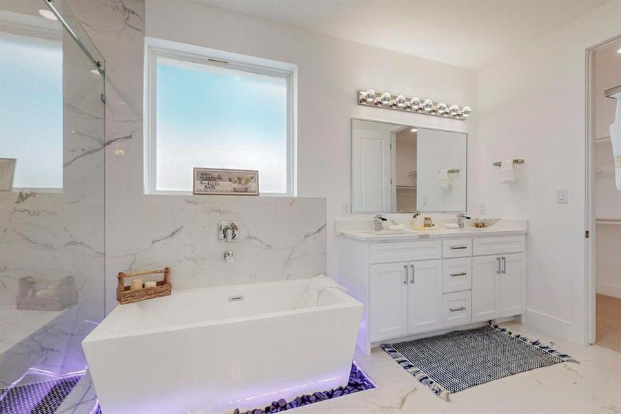 Bathroom with vanity and a bath