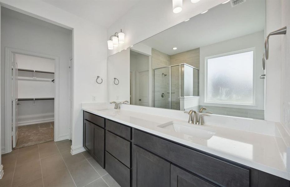 Spacious owner's bathroom with dual vanity *real home pictured