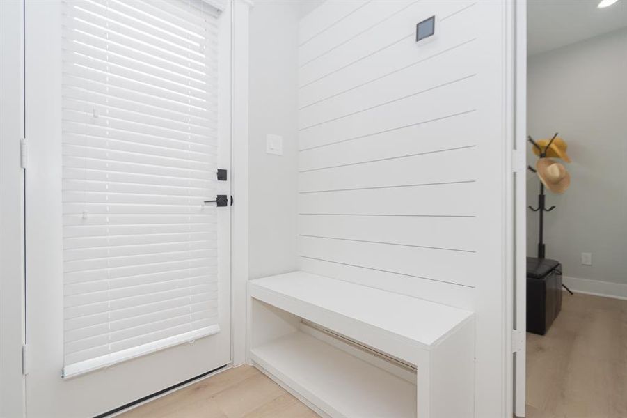 Discover the charm of the shiplap accent wall and a built-in bench on the first floor.