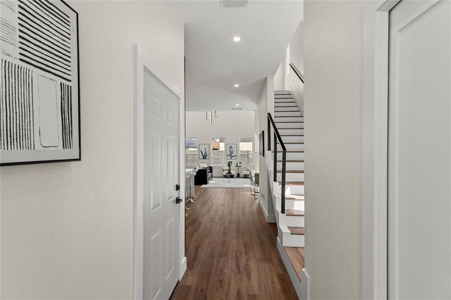 Corridor with dark wood finished floors and recessed lighting