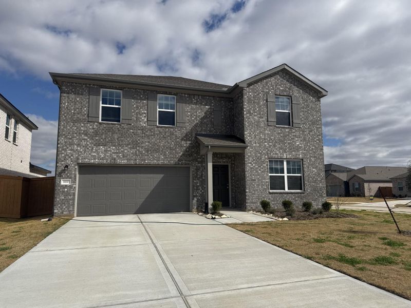 Front exterior of a new home in Sunterra Lakes, Brookshire, TX, highlighting curb appeal (Image 1). Front exterior of a new home in Sunterra Lakes, Brookshire, TX, highlighting curb appeal (Image 1).