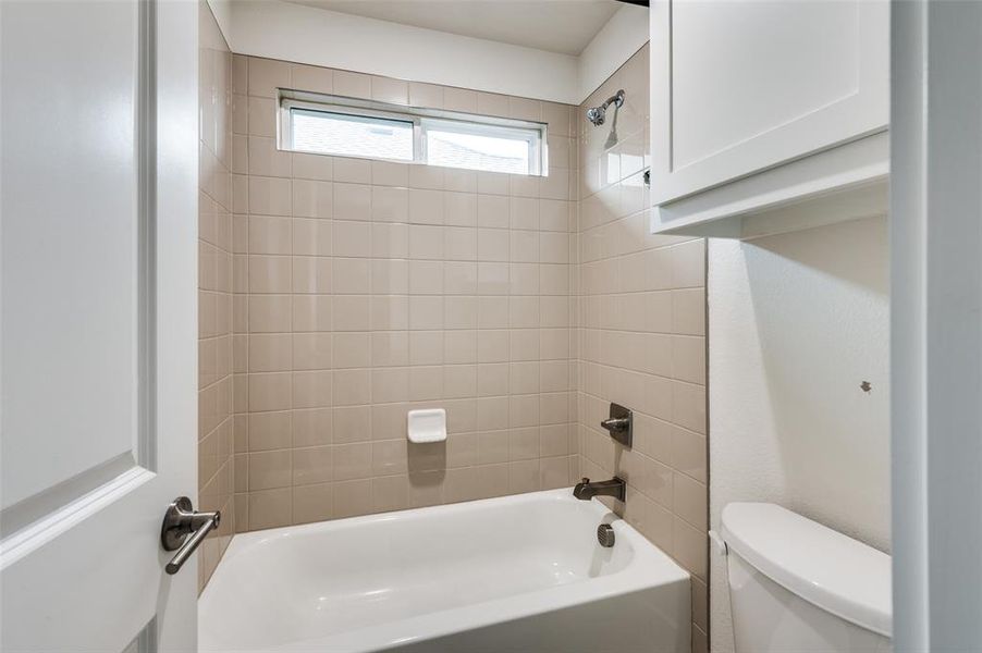 Bathroom featuring shower combination and toilet Bathroom featuring shower combination and toilet