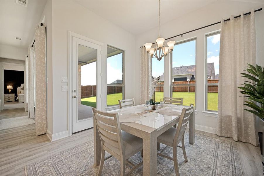 Surrounded by expansive windows and bathed in natural light, this elegant dining space offers picturesque backyard views and a seamless connection to the outdoor living area. The open layout and direct patio access create the perfect setting for intimate dinners, casual family meals, and effortless entertaining. Surrounded by expansive windows and bathed in natural light, this elegant dining space offers picturesque backyard views and a seamless connection to the outdoor living area. The open layout and direct patio access create the perfect setting for intimate dinners, casual family meals, and effortless entertaining.