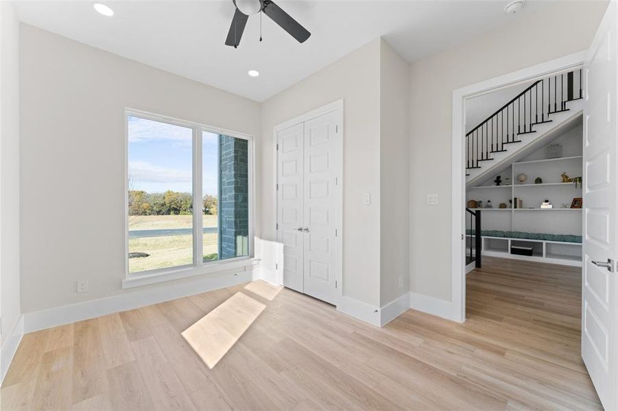 Unfurnished bedroom featuring light wood-type flooring, a ceiling fan, and recessed lighting Unfurnished bedroom featuring light wood-type flooring, a ceiling fan, and recessed lighting