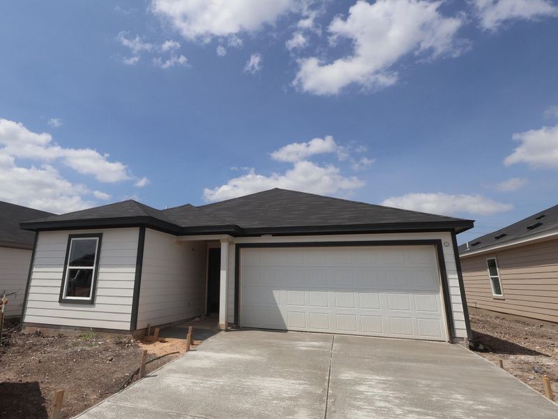 Front exterior of a new home in Marble Creek Crossing, Austin, TX, highlighting curb appeal (Image 5). Front exterior of a new home in Marble Creek Crossing, Austin, TX, highlighting curb appeal (Image 5).