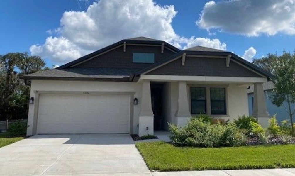 Front exterior of a new home in Pinecone Reserve, Brooksville, FL, highlighting curb appeal (Image 2). Front exterior of a new home in Pinecone Reserve, Brooksville, FL, highlighting curb appeal (Image 2).