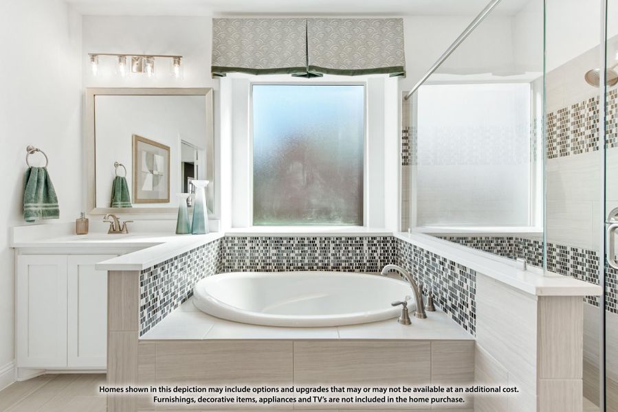 Master bathroom with soaking tub, mosaic tile surround, glass shower, and white vanity cabinets Master bathroom with soaking tub, mosaic tile surround, glass shower, and white vanity cabinets