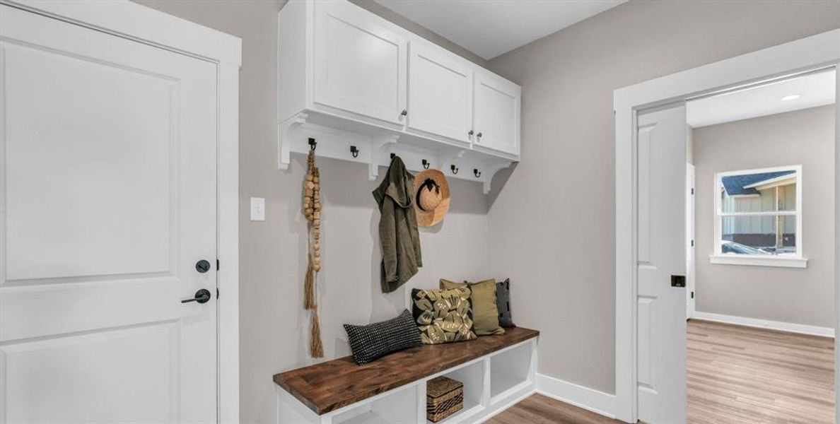 Mudroom with pocket door, bench and tons of storage. Door leads to garage