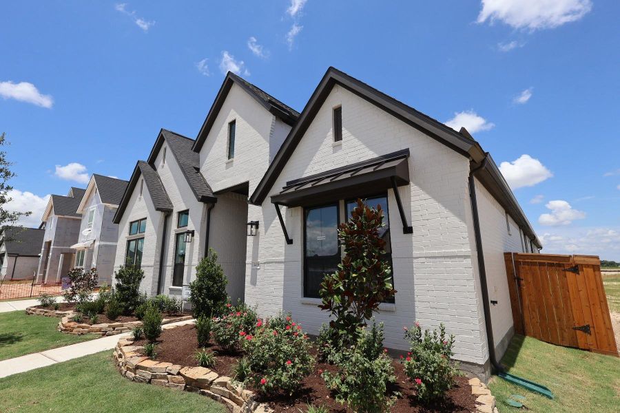 Front exterior of a new home in Dunham Pointe, Cypress, TX, highlighting curb appeal (Image 16). Front exterior of a new home in Dunham Pointe, Cypress, TX, highlighting curb appeal (Image 16).
