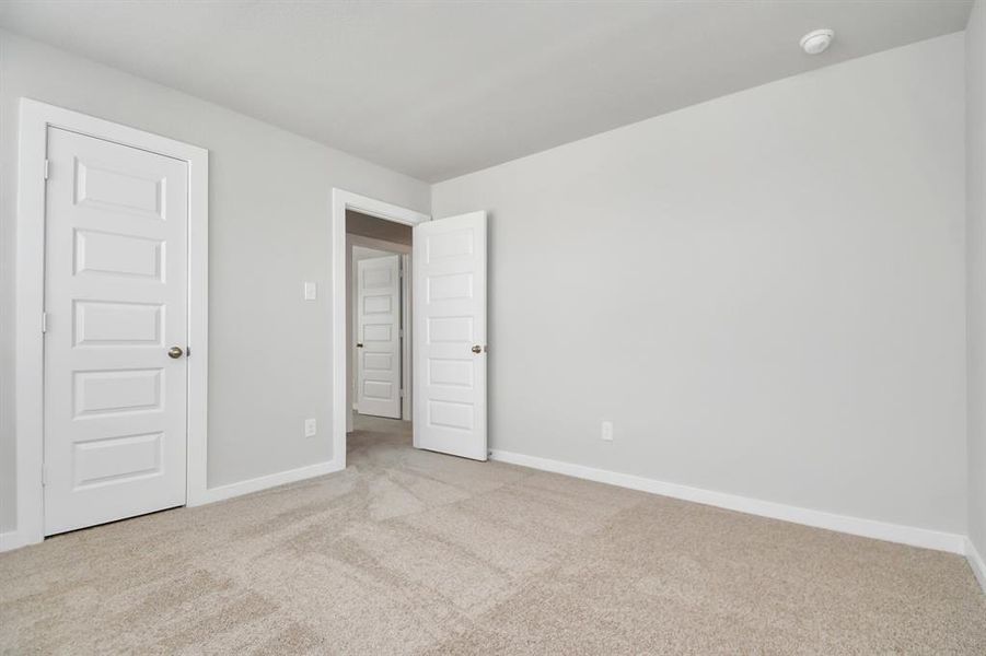 Generously sized secondary bedrooms featuring spacious closets, soft and inviting carpeting underfoot, large windows allowing plenty of natural light, and the added touch of privacy blinds for your personal retreat.