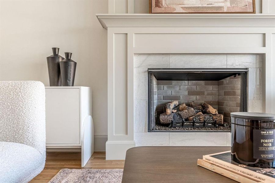 Detailed view of a fireplace and wood finished floors
