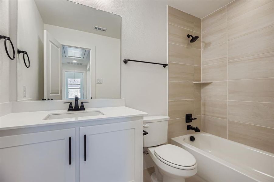 Full bathroom with bathing tub / shower combination and vanity Full bathroom with bathing tub / shower combination and vanity