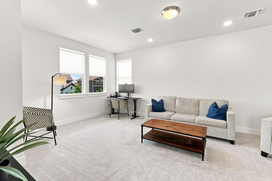 Expansive upstairs loft area offering a flexible secondary living space, game room, or media zone with upgraded recessed lighting. Expansive upstairs loft area offering a flexible secondary living space, game room, or media zone with upgraded recessed lighting.