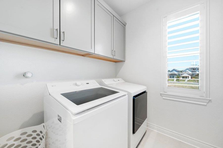 Ample built-in cabinetry and natural light enhance this functional utility space. Ample built-in cabinetry and natural light enhance this functional utility space.