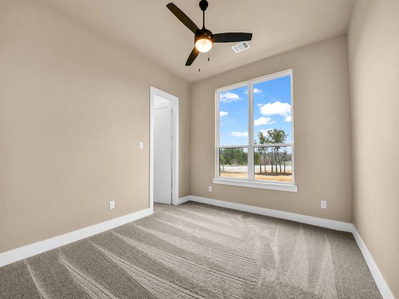 Spare room featuring ceiling fan and light carpet