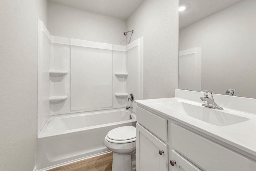 The secondary bathroom, located centrally in the hallway of the home.