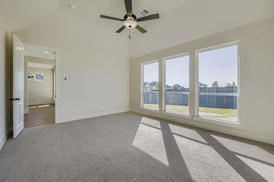 Unfurnished main bedoom featuring a wall of windows