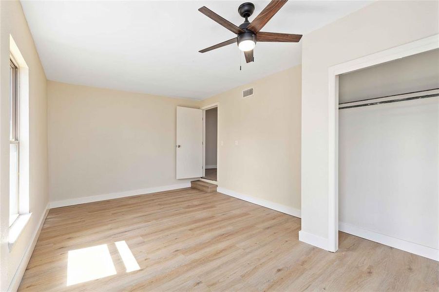 Unfurnished bedroom featuring light wood-type flooring, a ceiling fan, and a closet Unfurnished bedroom featuring light wood-type flooring, a ceiling fan, and a closet