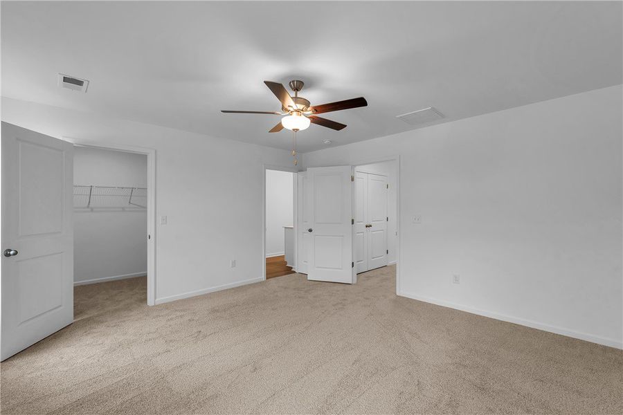 This spacious bedroom offers ample comfort and an This spacious bedroom offers ample comfort and an