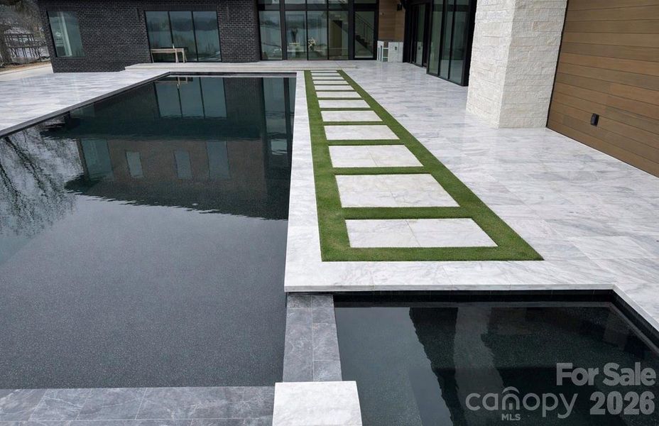 60’ Double Infinity Edge Saltwater Lap Pool w/ Cabo Shelf & Integrated Hot Tub- Accessible from Living Rooms, Kitchen, & Primary Suite