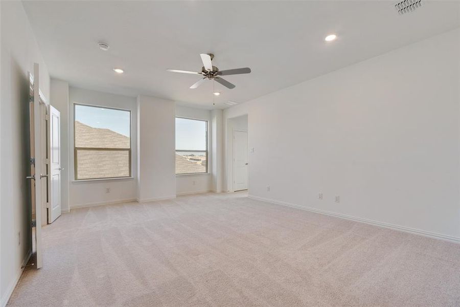 Spare room with light carpet and ceiling fan