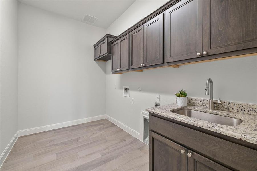 Spacious Laundry Room with Built In's and A Soaking Sink