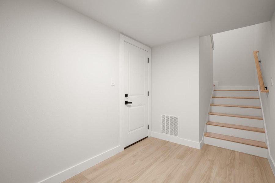 Stairway featuring baseboards and wood finished floors