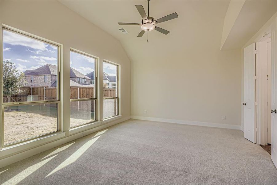 Unfurnished room featuring light carpet, a residential view, a ceiling fan, and high vaulted ceiling Unfurnished room featuring light carpet, a residential view, a ceiling fan, and high vaulted ceiling