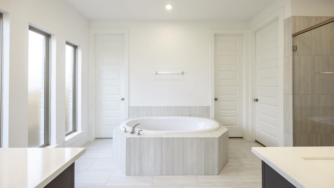 Full bathroom with vanity, a garden tub, a shower with shower door, tile patterned floors, and recessed lighting Full bathroom with vanity, a garden tub, a shower with shower door, tile patterned floors, and recessed lighting