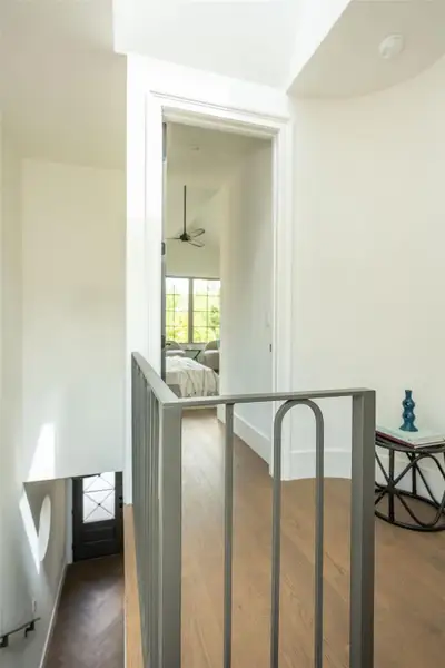 Warm hardwood floors and custom iron railings define this upper-level landing. Warm hardwood floors and custom iron railings define this upper-level landing.