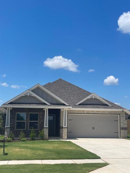 View of front facade with a garage and a front lawn